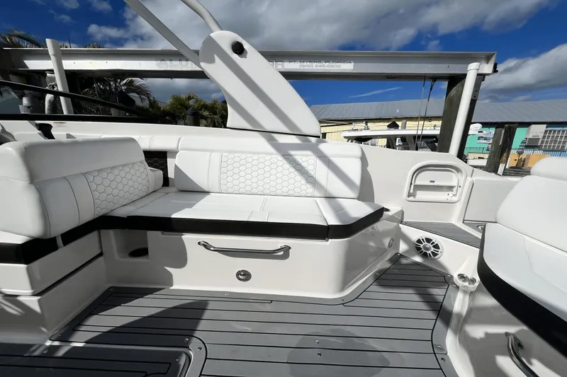 Slide: The Image of 2019 Sea Ray SDX 270 Outboard boat interior with white seating and modern design. - 11