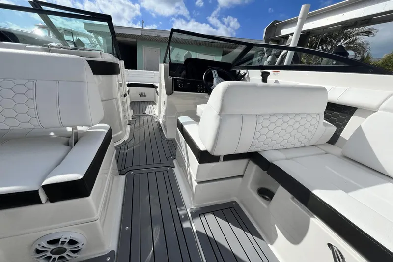 Slide: The Image of 2019 Sea Ray SDX 270 Outboard interior with white seating and modern dashboard. - 12