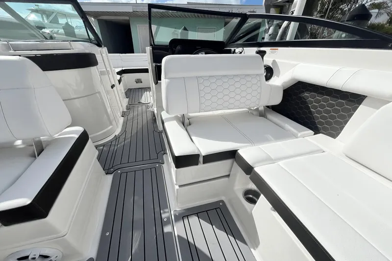 Slide: The Image of 2019 Sea Ray SDX 270 Outboard interior with white and black seating. - 13