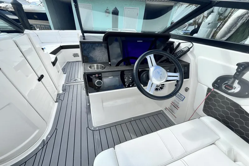 Slide: The Image of 2019 Sea Ray SDX 270 Outboard boat cockpit with steering wheel, controls, and seating. - 15