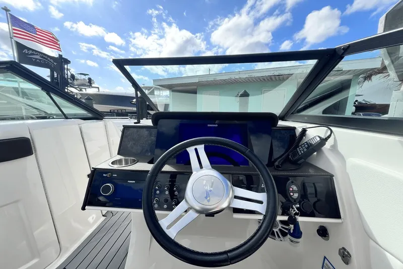 Slide: The Image of 2019 Sea Ray SDX 270 Outboard boat dashboard with steering wheel and control panel. - 16