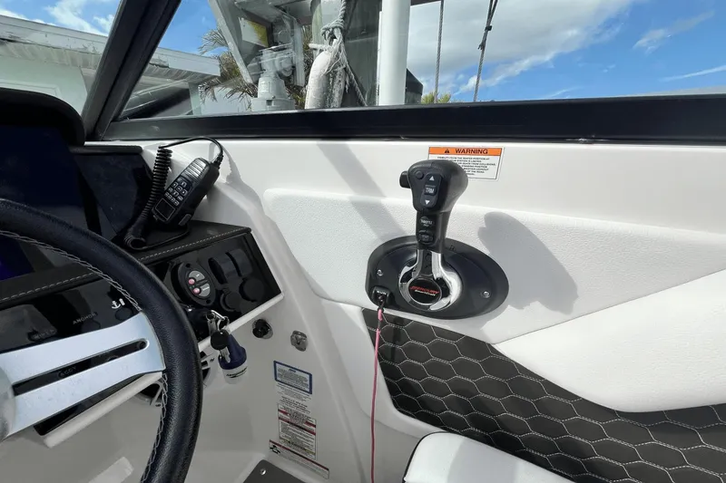 Slide: The Image of 2019 Sea Ray SDX 270 Outboard helm with controls and steering wheel. - 17