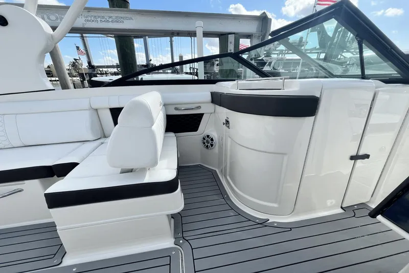 Slide: The Image of 2019 Sea Ray SDX 270 Outboard boat interior with white seating and black accents. - 18