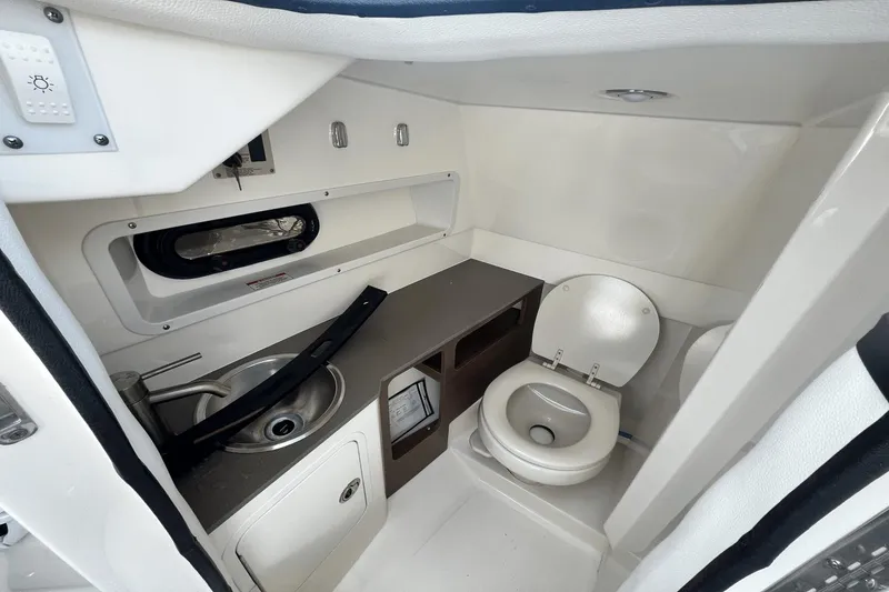 Slide: The Image of 2019 Sea Ray SDX 270 Outboard boat bathroom with sink and toilet. - 19