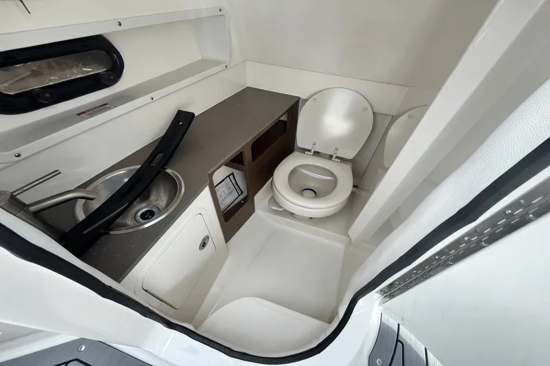 Slide: The Image of 2019 Sea Ray SDX 270 Outboard boat bathroom with sink and toilet. - 20