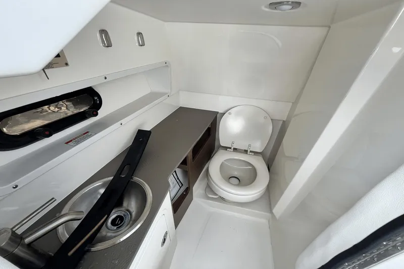 Slide: The Image of 2019 Sea Ray SDX 270 Outboard boat bathroom with sink and toilet. - 21