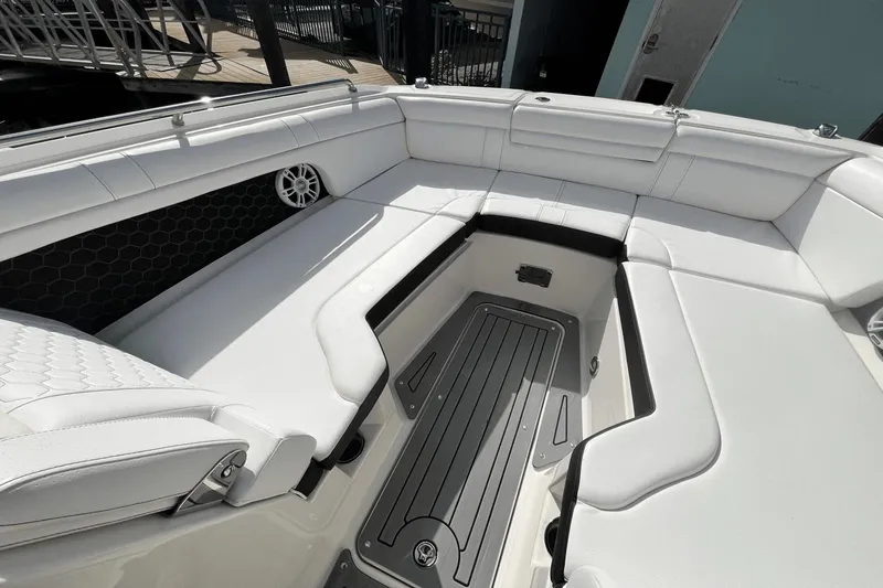 Slide: The Image of 2019 Sea Ray SDX 270 Outboard boat interior with white cushioned seating. - 22
