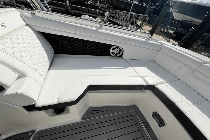 Slide: The Image of 2019 Sea Ray SDX 270 Outboard boat interior with white seating and speaker. - 23