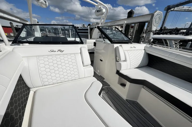 Slide: The Image of 2019 Sea Ray SDX 270 Outboard boat interior with white cushioned seating. - 25