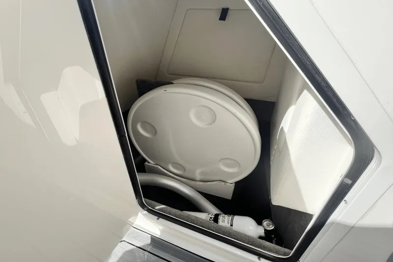 Slide: The Image of Storage compartment of a 2019 Sea Ray SDX 270 Outboard boat with a fire extinguisher. - 27