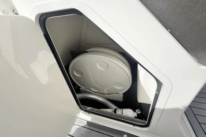 Slide: The Image of Storage compartment on a 2019 Sea Ray SDX 270 Outboard boat with a fire extinguisher. - 28