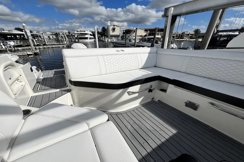 Slide: The Image of 2019 Sea Ray SDX 270 Outboard boat interior with white seating at marina. - 7