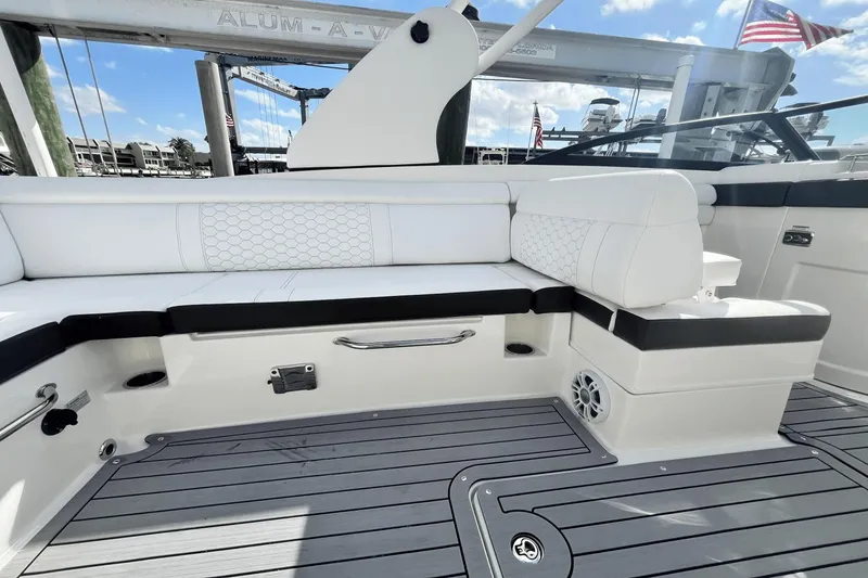 Slide: The Image of 2019 Sea Ray SDX 270 Outboard boat interior with white seating and gray deck. - 8