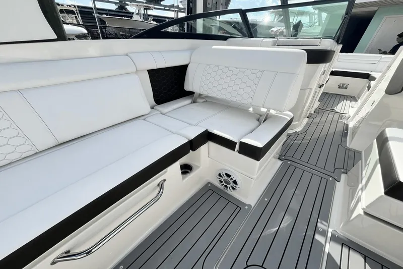 Slide: The Image of 2019 Sea Ray SDX 270 Outboard boat interior with white seating and gray flooring. - 9
