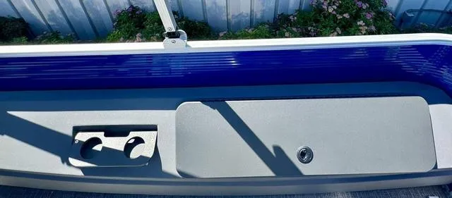 Slide: The Image of 2024 Bennington 20 SVF boat interior with cup holders and storage compartment. - 17