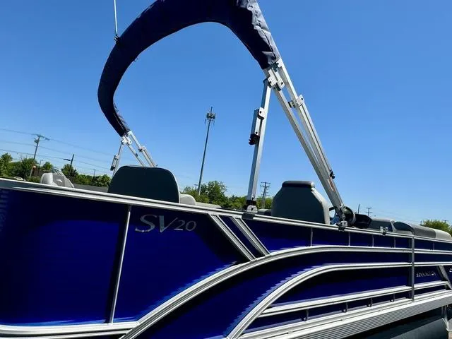 Slide: The Image of 2024 Bennington 20 SVF pontoon boat with blue exterior and canopy. - 21