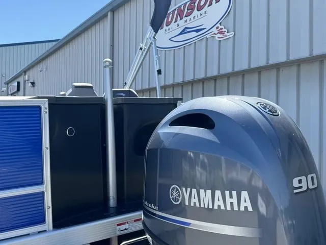 Slide: The Image of 2024 Bennington 20 SVF with Yamaha 90 outboard motor at a marine dealership. - 24