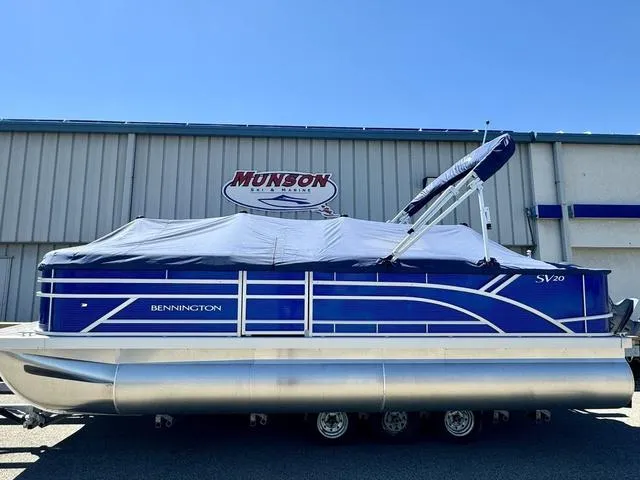Slide: The Image of 2024 Bennington 20 SVF pontoon boat in blue, covered and on a trailer. - 25