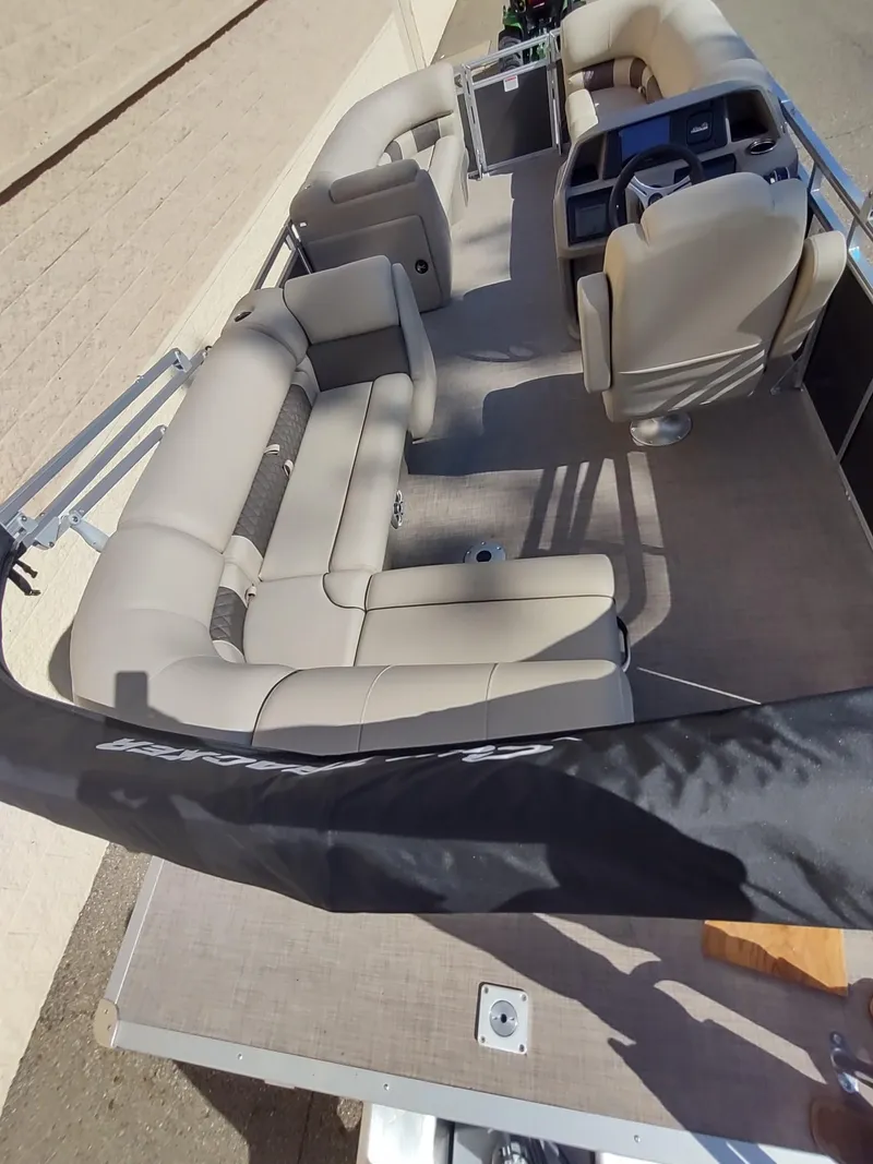 Slide: The Image of 2024 Sun Tracker Party Barge 20 DLX pontoon boat interior with beige seating. - 5