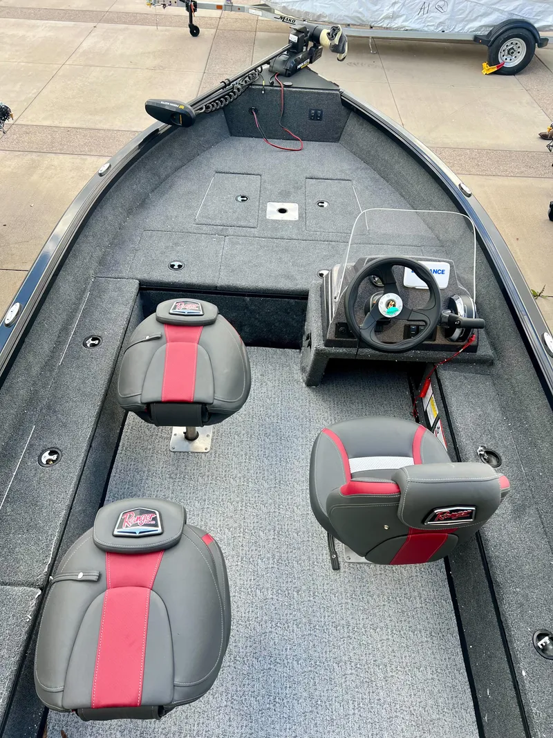 Slide: The Image of 2024 Ranger VS1665SC fishing boat interior with dual seats and steering console. - 2