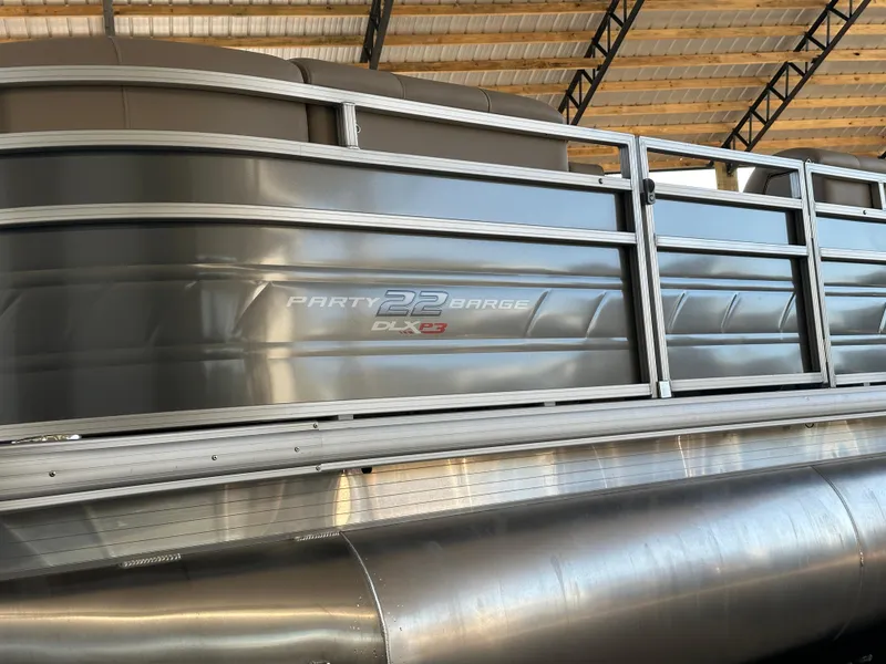 Slide: The Image of 2024 Sun Tracker Party Barge 22 RF XP3 pontoon boat under a covered dock. - 3