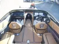 Slide: The Image of 2024 Crownline 240LPX boat interior with tan seats and wood flooring. - 10