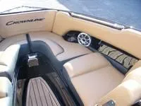 Slide: The Image of 2024 Crownline 240LPX boat interior with tan seating and built-in speaker. - 4