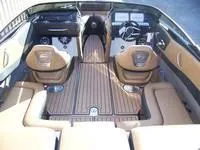 Slide: The Image of 2024 Crownline 240LPX boat interior with tan seating and wood flooring. - 8