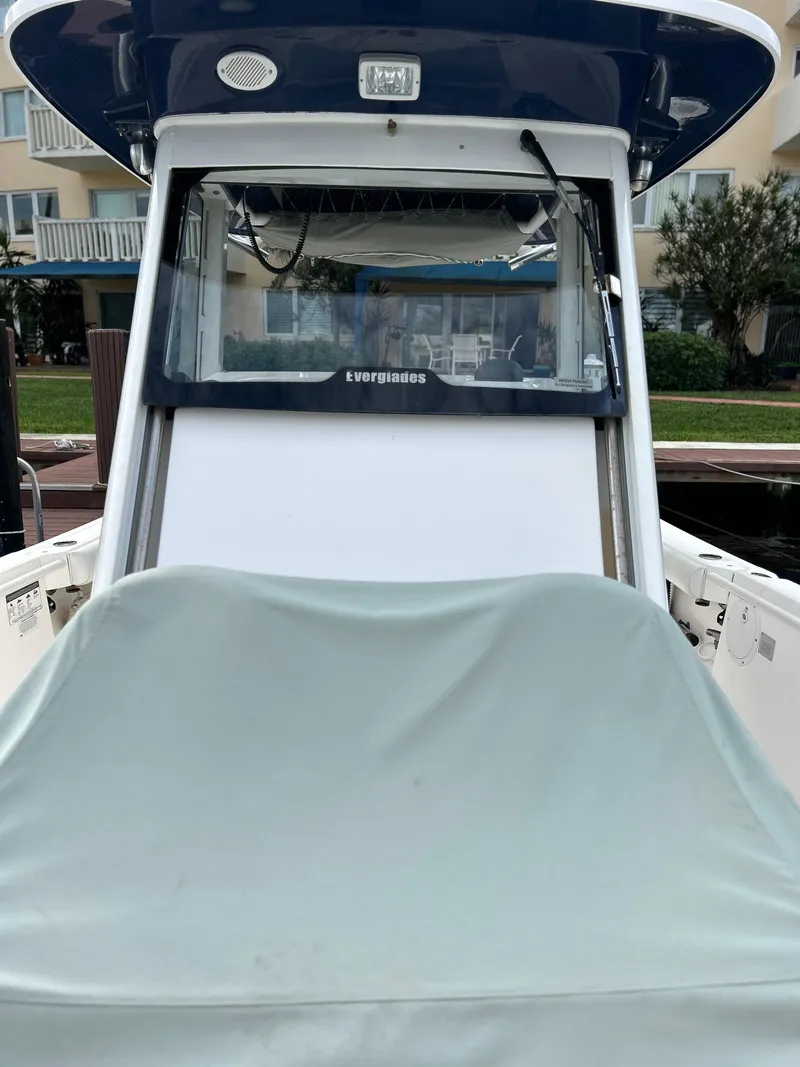 Slide: The Image of 2012 Everglades 295 Center Console boat docked at a marina. - 10