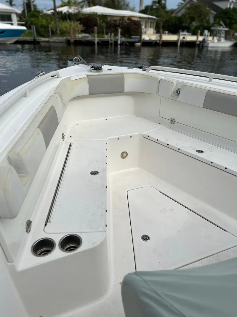 Slide: The Image of 2012 Everglades 295 Center Console boat interior with seating and storage compartments. - 11