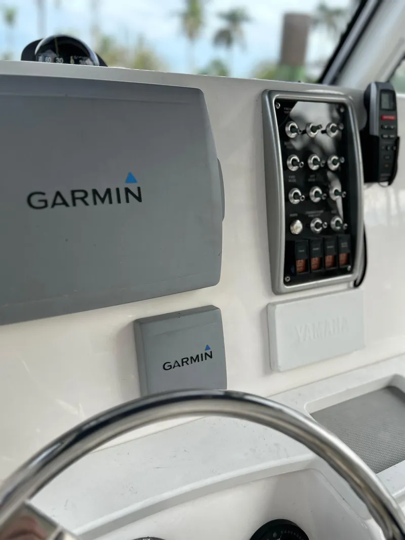 Slide: The Image of Control panel of a 2012 Everglades 295 Center Console boat with Garmin electronics. - 12