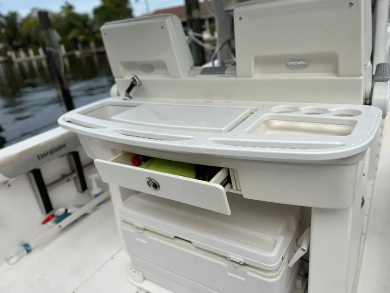 Slide: The Image of 2012 Everglades 295 Center Console boat with storage compartments and cutting board. - 14