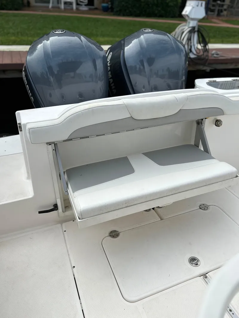 Slide: The Image of 2012 Everglades 295 Center Console boat with dual outboard engines and foldable seat. - 15