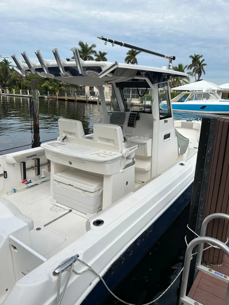 Slide: The Image of 2012 Everglades 295 Center Console boat docked by the water. - 16