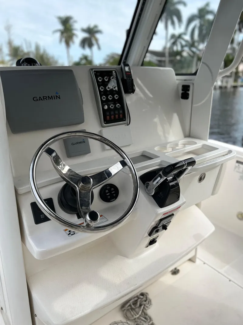 Slide: The Image of 2012 Everglades 295 Center Console helm with Garmin navigation system. - 18