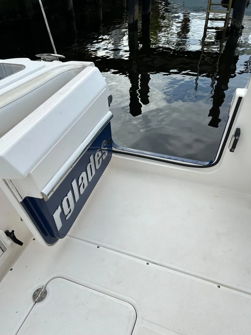 Slide: The Image of 2012 Everglades 295 Center Console boat interior near water. - 6