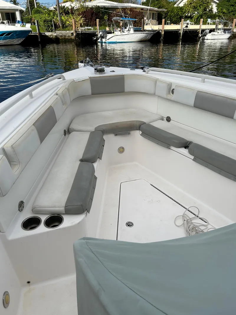 Slide: The Image of 2012 Everglades 295 Center Console boat with cushioned seating in a marina. - 7