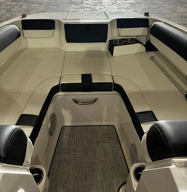 Slide: The Image of 2024 Bayliner DX 2000 boat interior with cushioned seating and cup holders. - 11