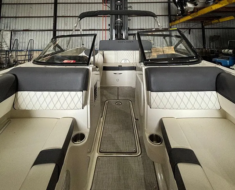Slide: The Image of 2024 Bayliner DX 2000 boat interior with cushioned seating and modern design. - 14
