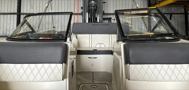 Slide: The Image of 2024 Bayliner DX 2000 boat interior with dual windshields and diamond-stitched seating. - 15