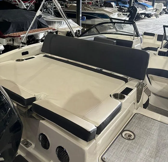 Slide: The Image of 2024 Bayliner DX 2000 boat interior with seating and cup holders. - 16