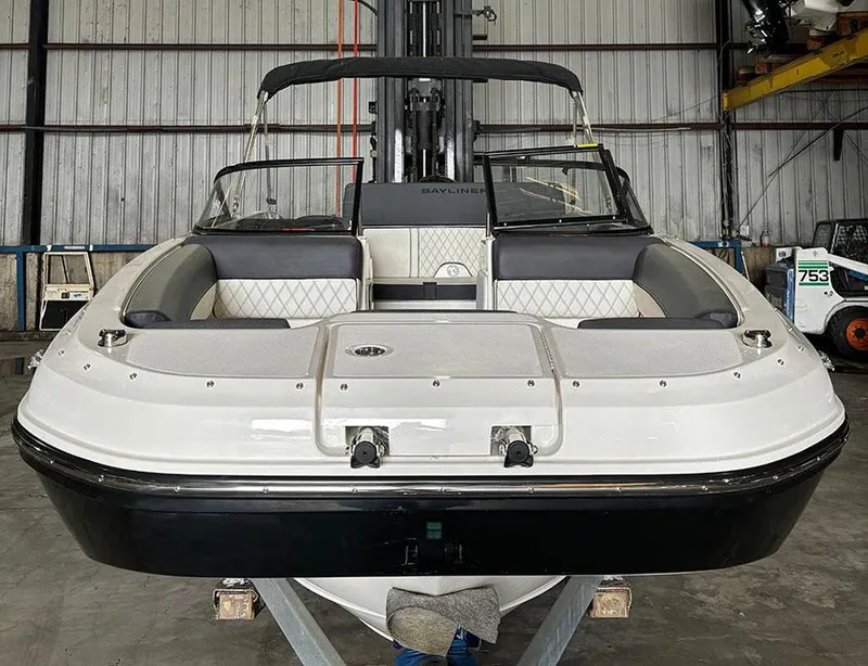 Slide: The Image of 2024 Bayliner DX 2000 boat in a warehouse. - 2