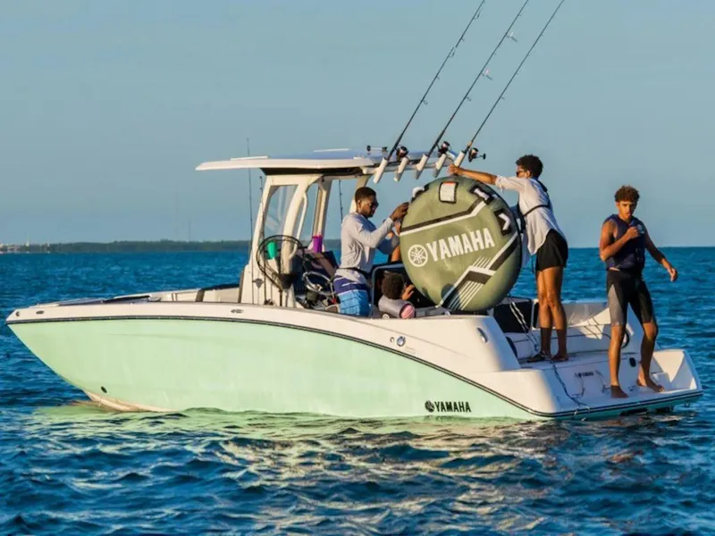 Slide: The Image of 2024 Yamaha Boats 255 FSH Sport E on water with people fishing. - 4