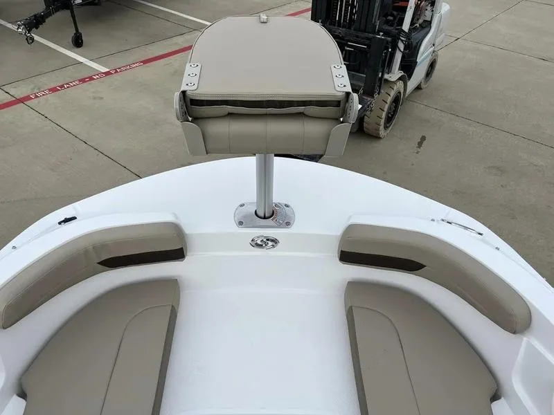 Slide: The Image of 2023 Hurricane SS185-OB boat interior with beige seating and a central pedestal seat. - 10