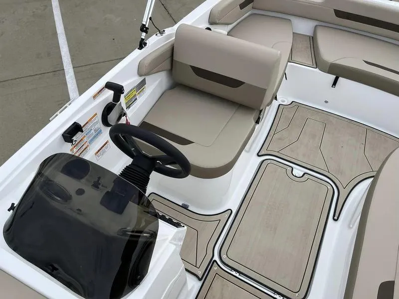 Slide: The Image of 2023 Hurricane SS185-OB boat interior with beige seating and modern dashboard. - 12