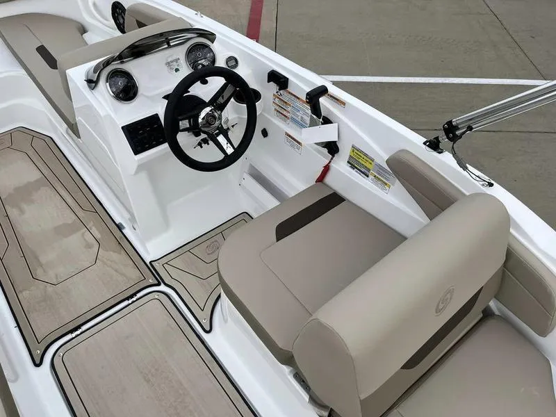 Slide: The Image of 2023 Hurricane SS185-OB boat interior with steering wheel and beige seating. - 15