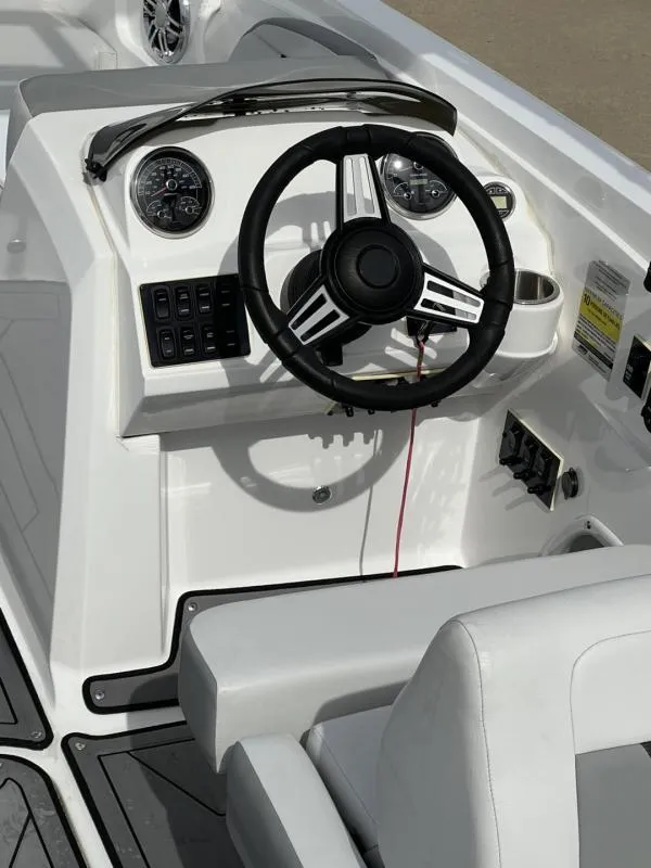 Slide: The Image of 2023 Hurricane SS205-IO 4.5 MPI boat dashboard with steering wheel and controls. - 11