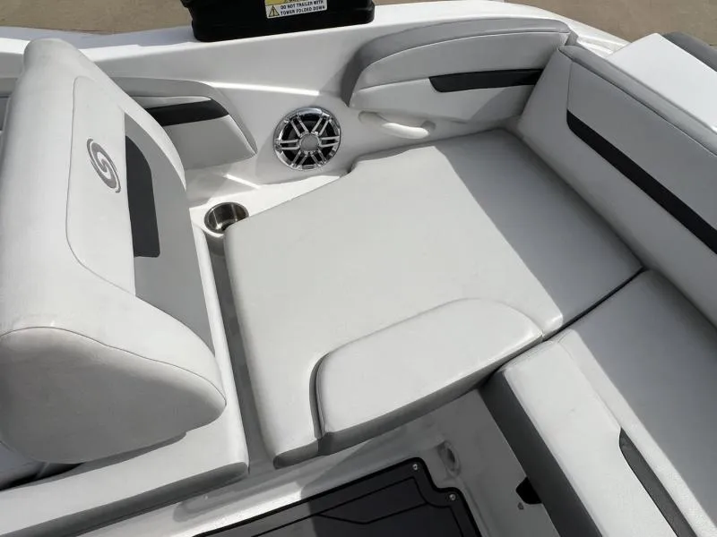 Slide: The Image of 2023 Hurricane SS205-IO 4.5 MPI boat interior with white cushioned seating and speaker. - 14