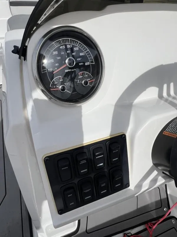 Slide: The Image of Dashboard of 2023 Hurricane SS205-IO 4.5 MPI boat with speedometer and control switches. - 22