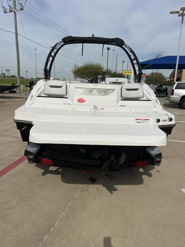 Slide: The Image of 2023 Hurricane SS205-IO 4.5 MPI boat, rear view, parked on concrete. - 4